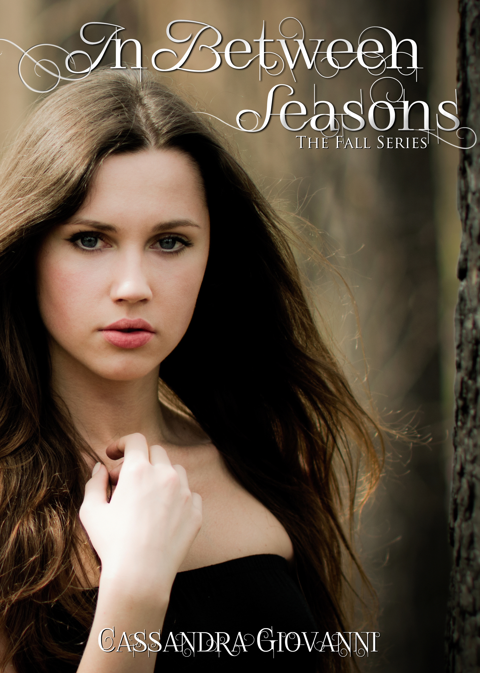 Attractive young woman near tree trunk